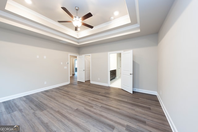 5587 Spring St, Flowery Branch, GA 30542 - unfurnished bedroom featuring a tray ceiling, dark wood-style flooring, recessed lighting, and ceiling fan