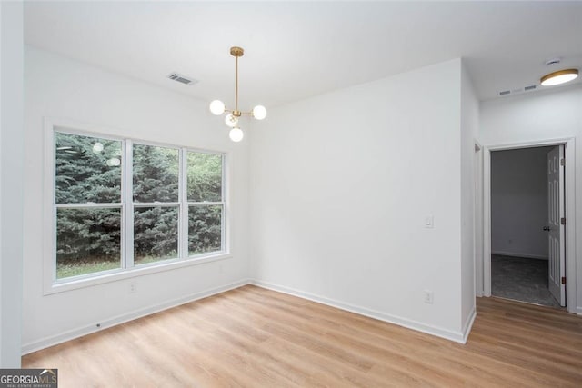 3314 Dilmus Dr, Powder Springs, GA 30127 - unfurnished dining area featuring light wood finished floors, baseboards, and a chandelier