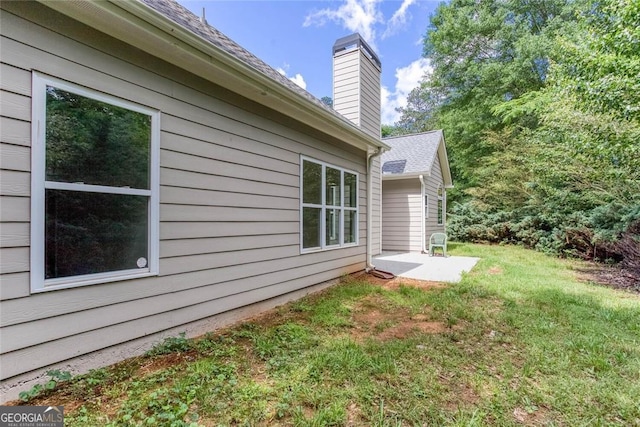 3314 Dilmus Dr, Powder Springs, GA 30127 - view of side of property with a chimney, a lawn, and a patio