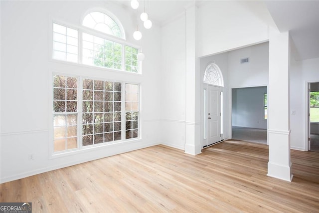 3314 Dilmus Dr, Powder Springs, GA 30127 - foyer entrance featuring a high ceiling, light wood-style flooring, and baseboards