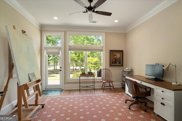 office space with ceiling fan, visible vents, wood finished floors, baseboards, and ornamental molding