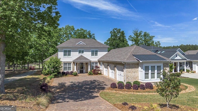 view of front of house featuring a garage and decorative driveway