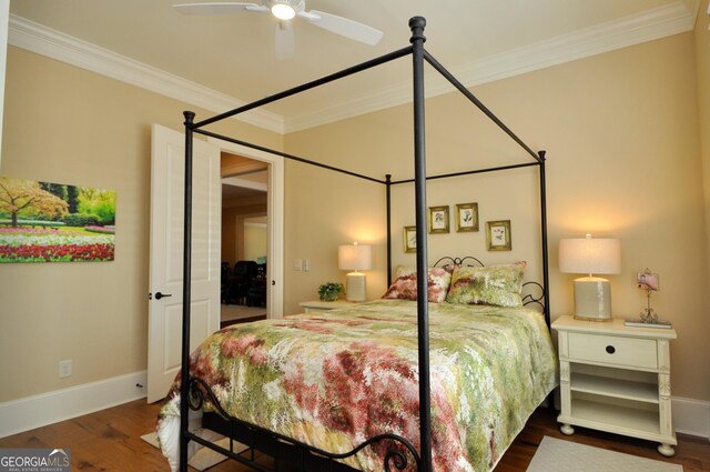 bedroom with baseboards, ornamental molding, ceiling fan, and wood finished floors