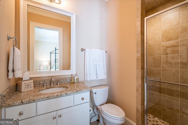 full bathroom featuring vanity, a stall shower, and toilet