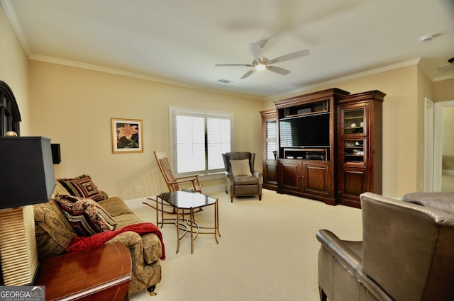 living area with crown molding, a ceiling fan, carpet flooring, and visible vents