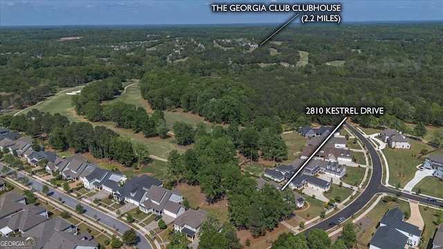 bird's eye view featuring a residential view and a wooded view