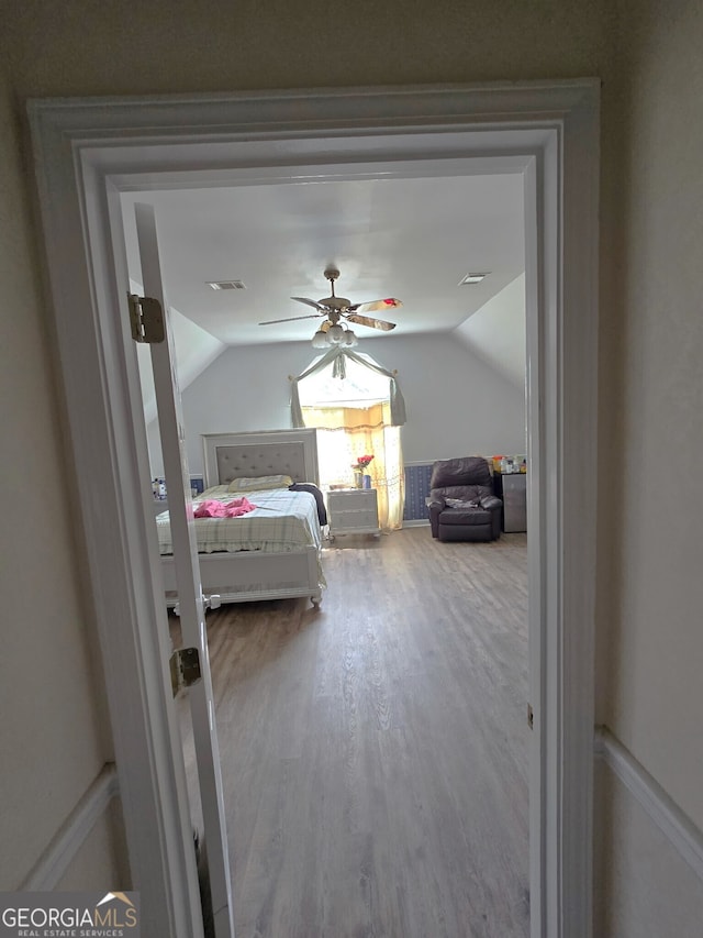 345 Oak Springs Dr NW, Lawrenceville, GA 30043 - bedroom with wood finished floors, lofted ceiling, and a ceiling fan