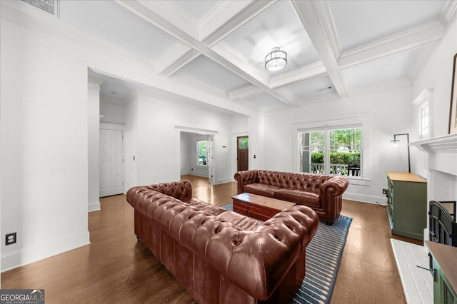 living room featuring wood finished floors, coffered ceiling, beam ceiling, a fireplace, and visible vents
