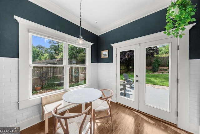 dining area featuring french doors, wood finished floors, and ornamental molding