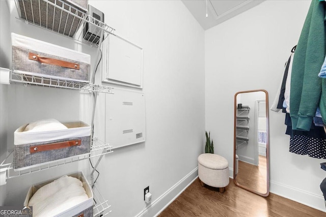 spacious closet featuring attic access and wood finished floors