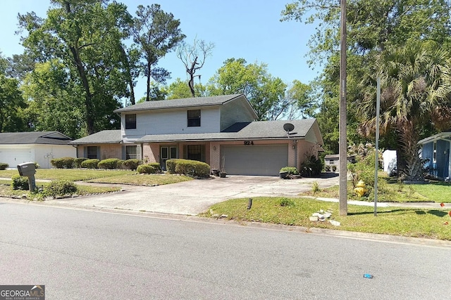 traditional home with an attached garage, brick siding, a front yard, and concrete driveway
