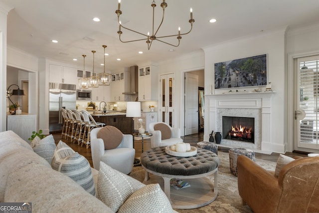 living room featuring ornamental molding, an inviting chandelier, recessed lighting, and dark wood-type flooring