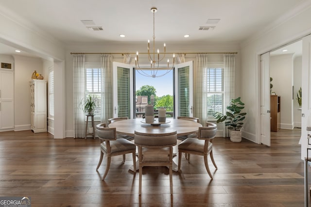 dining room featuring an inviting chandelier, ornamental molding, and visible vents