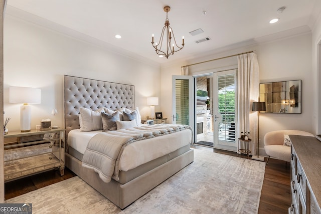 bedroom featuring crown molding, access to outside, wood finished floors, and an inviting chandelier