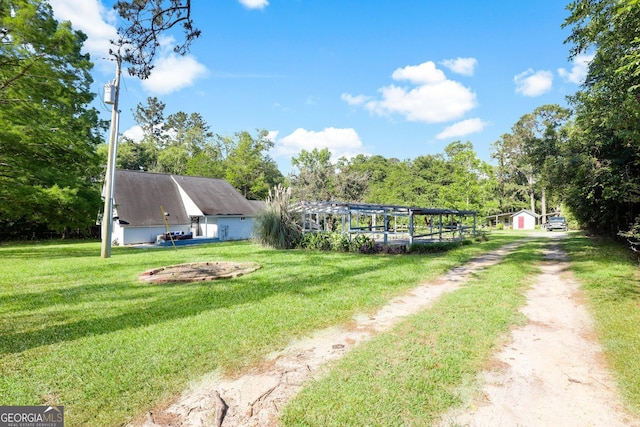 view of property's community featuring a lawn and view of scattered trees