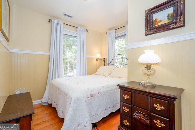 0 Vinson Mountain Rd, Rockmart, GA 30153 - bedroom featuring a wainscoted wall, wood finished floors, and visible vents