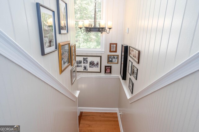 0 Vinson Mountain Rd, Rockmart, GA 30153 - staircase with wooden walls, wood finished floors, a chandelier, and a wainscoted wall