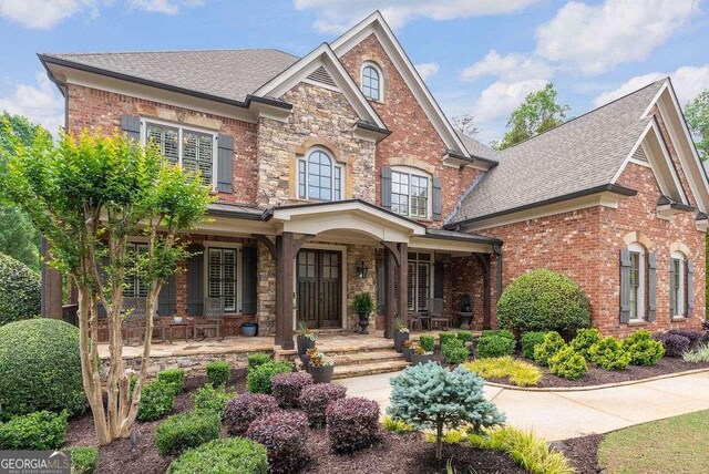5475 Copper Creek Pass, Cumming, GA 30040 - view of front of house with covered porch, brick siding, and a shingled roof