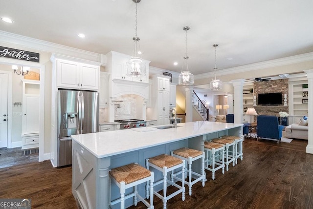 5475 Copper Creek Pass, Cumming, GA 30040 - kitchen featuring stainless steel refrigerator with ice dispenser, a sink, crown molding, open floor plan, and stove