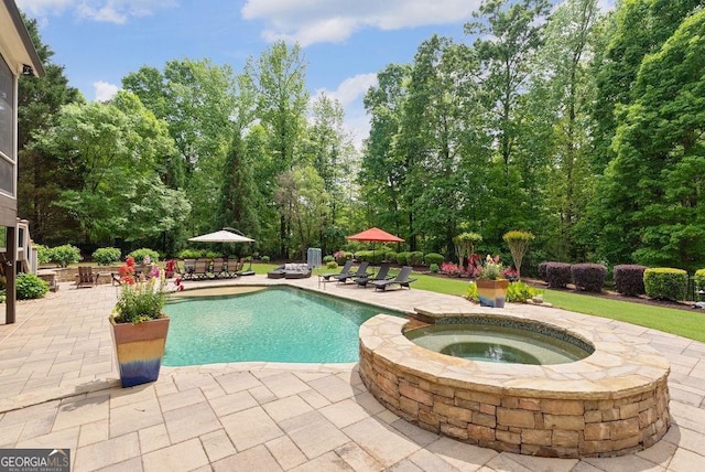 5475 Copper Creek Pass, Cumming, GA 30040 - view of pool featuring a patio, view of wooded area, and a pool with connected hot tub