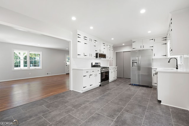 2690 Old Hickory Dr NW, Marietta, GA 30064 - kitchen featuring stainless steel appliances, light countertops, recessed lighting, a sink, and dark tile patterned floors