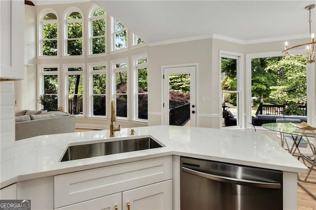 kitchen featuring white cabinetry, plenty of natural light, a sink, and dishwasher