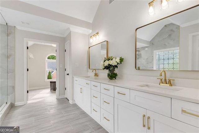 full bath with double vanity, baseboards, a sink, and a stall shower