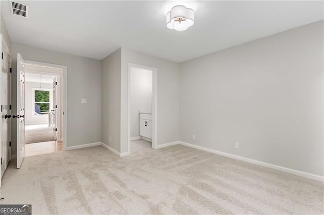unfurnished bedroom with light colored carpet, baseboards, and visible vents