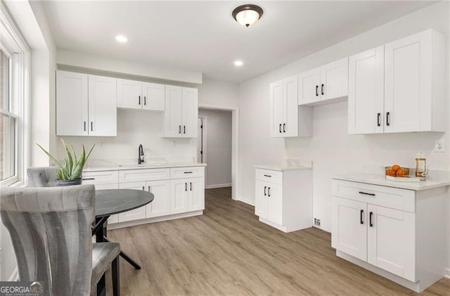 kitchen with white cabinetry, recessed lighting, and light wood-style floors