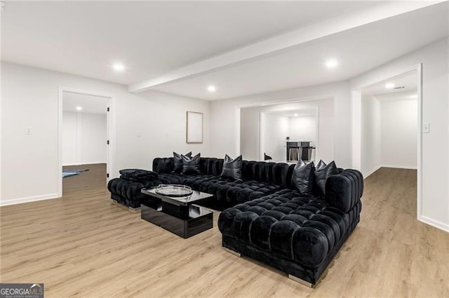 living area featuring recessed lighting, baseboards, and wood finished floors