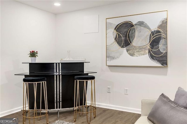 interior space featuring baseboards and wood finished floors