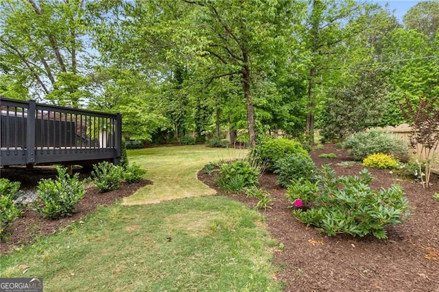 view of yard featuring a wooden deck