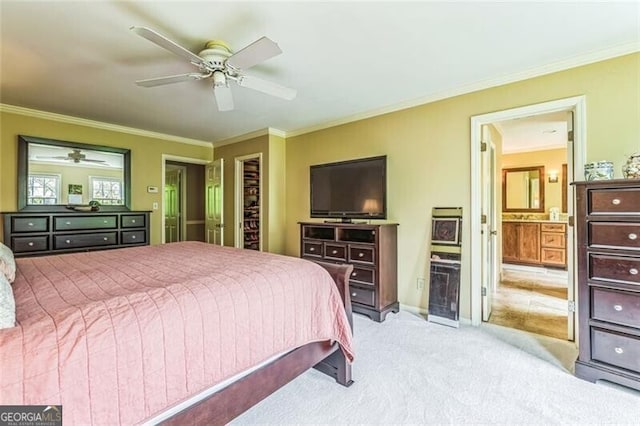 bedroom featuring ceiling fan, ensuite bath, ornamental molding, and light carpet