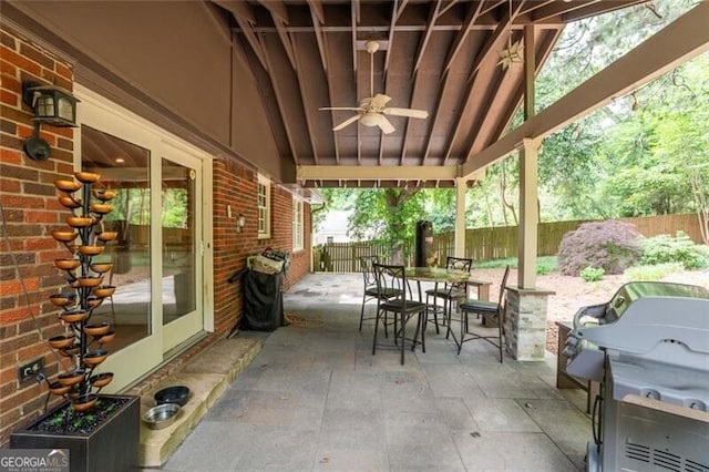 view of patio featuring outdoor dining area, a fenced backyard, ceiling fan, and area for grilling