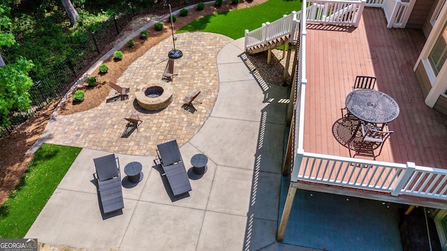 view of patio / terrace with a wooden deck and an outdoor fire pit