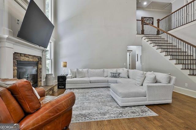 255 Ashmere Ct, Tyrone, GA 30290 - living room with a high ceiling, wood finished floors, stairway, a fireplace, and baseboards