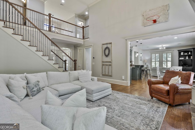 255 Ashmere Ct, Tyrone, GA 30290 - living area featuring crown molding, stairs, wood finished floors, baseboards, and a towering ceiling