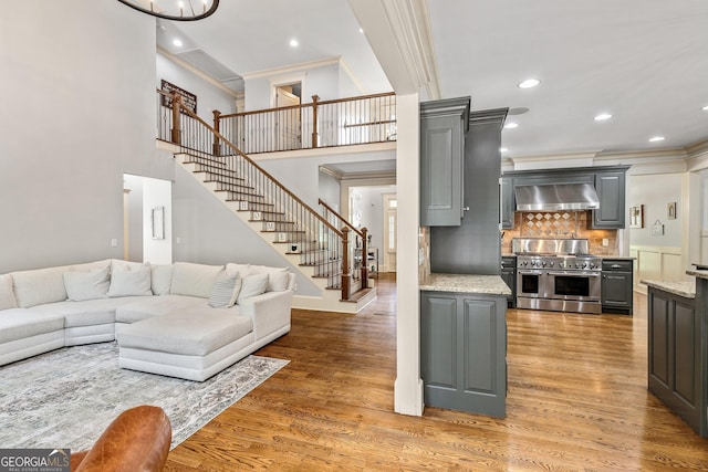 255 Ashmere Ct, Tyrone, GA 30290 - living room with ornamental molding, stairway, light wood-style floors, recessed lighting, and baseboards