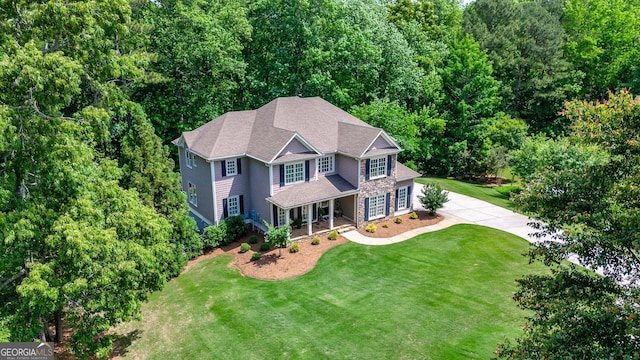 255 Ashmere Ct, Tyrone, GA 30290 - view of front facade featuring a front lawn, covered porch, driveway, and stone siding