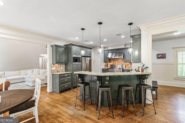 255 Ashmere Ct, Tyrone, GA 30290 - kitchen featuring gray cabinetry, wall chimney exhaust hood, stainless steel appliances, a peninsula, and ornamental molding