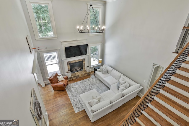 255 Ashmere Ct, Tyrone, GA 30290 - living room featuring a high ceiling, stairway, healthy amount of natural light, and wood finished floors
