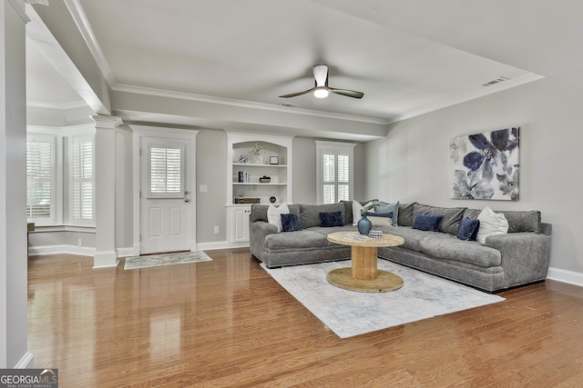 255 Ashmere Ct, Tyrone, GA 30290 - living room featuring crown molding, ceiling fan, wood finished floors, baseboards, and decorative columns