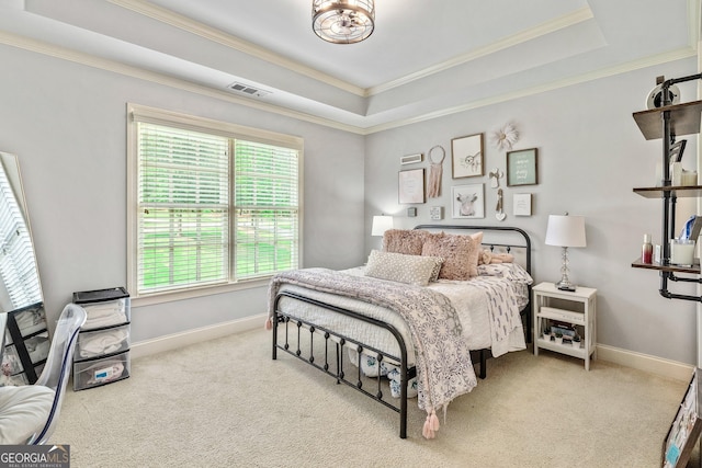 carpeted bedroom with visible vents, baseboards, crown molding, and a tray ceiling
