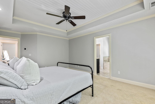 carpeted bedroom featuring crown molding, baseboards, a tray ceiling, and visible vents