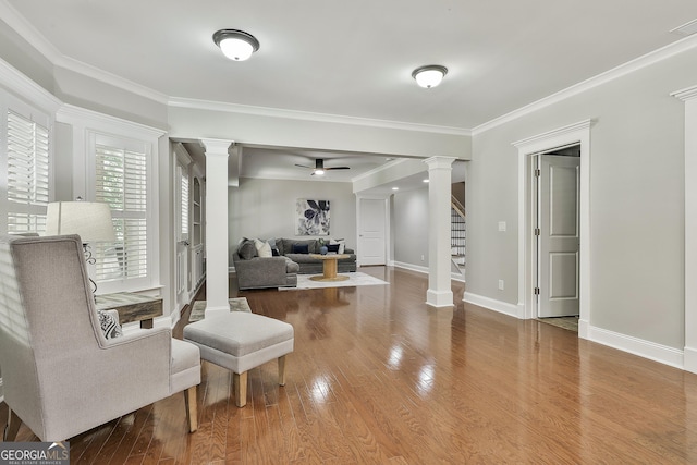 255 Ashmere Ct, Tyrone, GA 30290 - living area featuring decorative columns, ornamental molding, wood finished floors, stairs, and baseboards