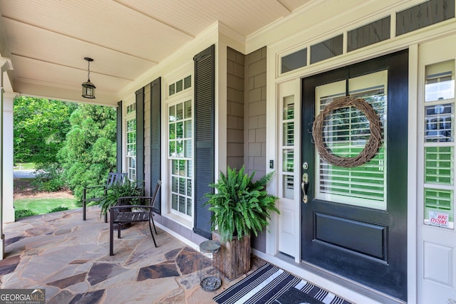view of exterior entry with covered porch