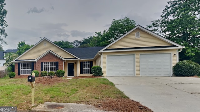 1229 Huntington Place Cir, Lithonia, GA 30058 - view of front facade featuring an attached garage, a front lawn, brick siding, and concrete driveway