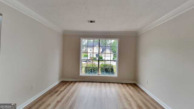 1229 Huntington Place Cir, Lithonia, GA 30058 - spare room with visible vents, ornamental molding, light wood-style flooring, and baseboards