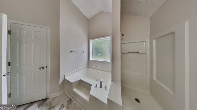 1229 Huntington Place Cir, Lithonia, GA 30058 - bathroom featuring marble finish floor, vaulted ceiling, a garden tub, and a shower