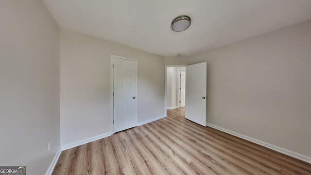 1229 Huntington Place Cir, Lithonia, GA 30058 - unfurnished bedroom with baseboards and light wood finished floors